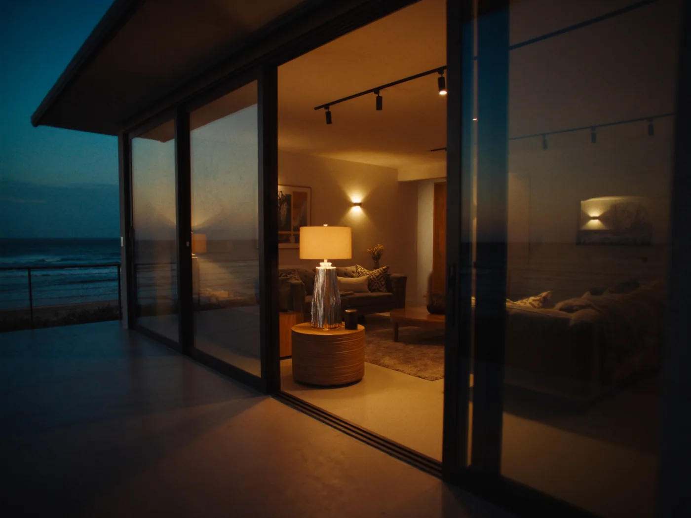 Black multi-panel sliding patio door opening onto a patio at dusk