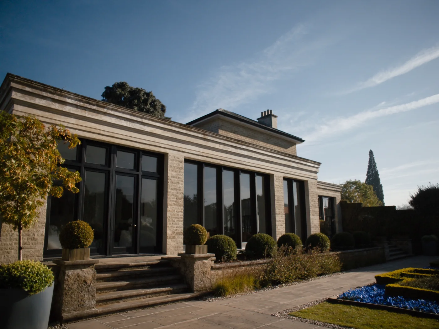 Broadmoor estate home with oversized new windows in crisp sunlight