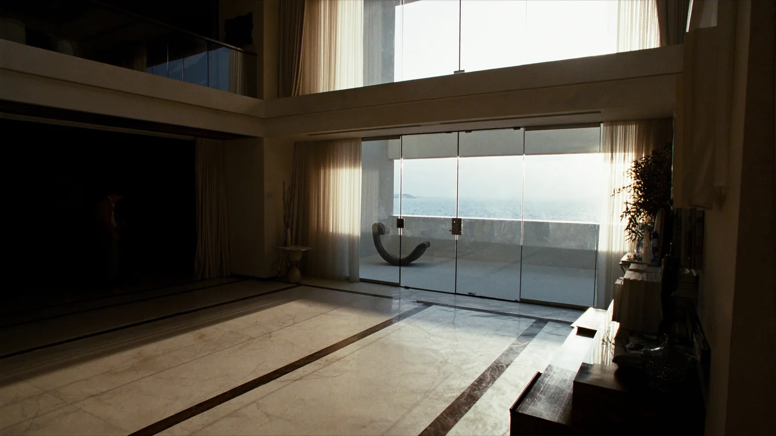 Double-height great room with new floor-to-ceiling windows and sunbeams