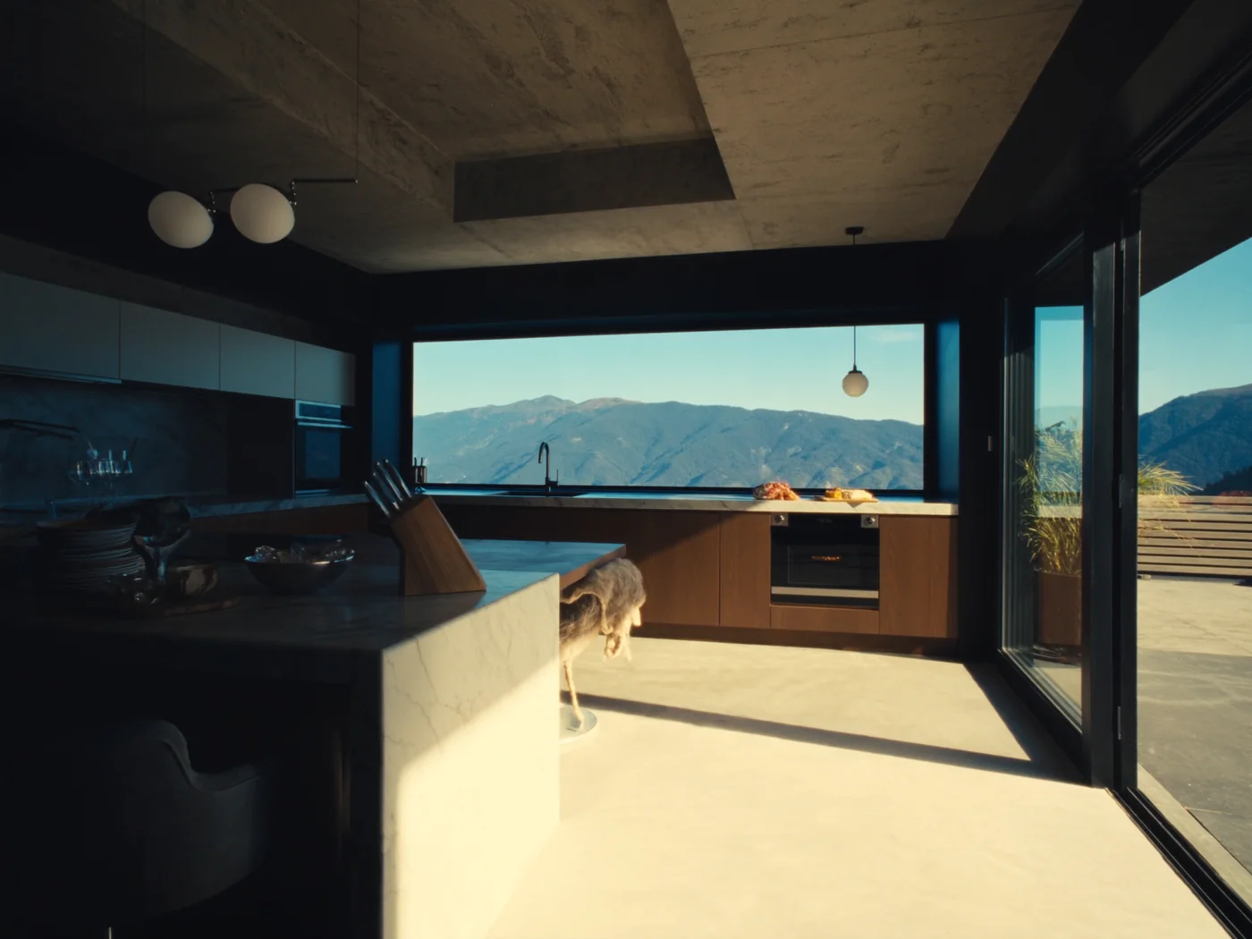 Nine-foot picture window over a marble island in a Clyde Hill kitchen